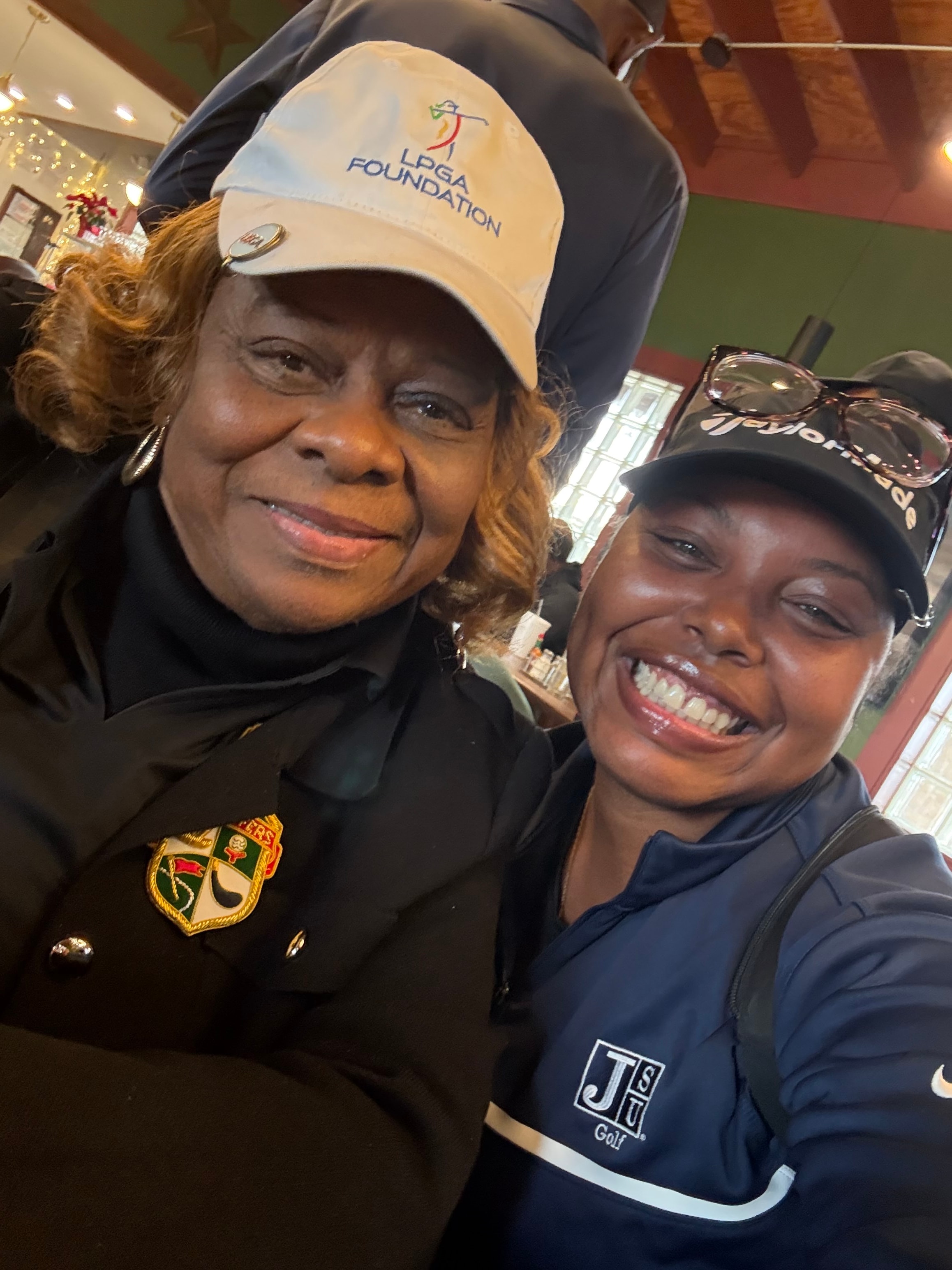 Golf instructor coaching woman on course